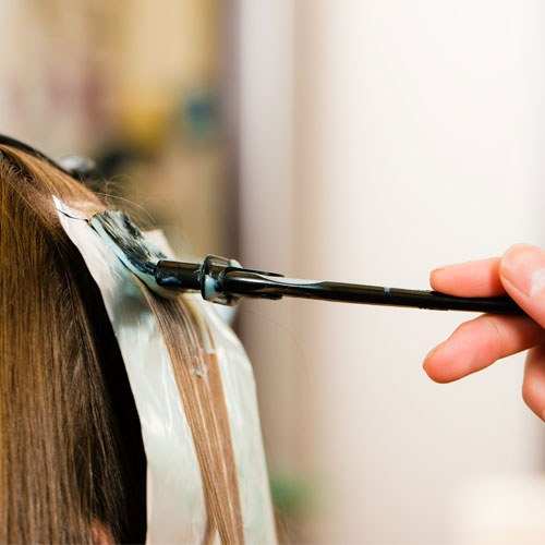Hair color being applied with foils