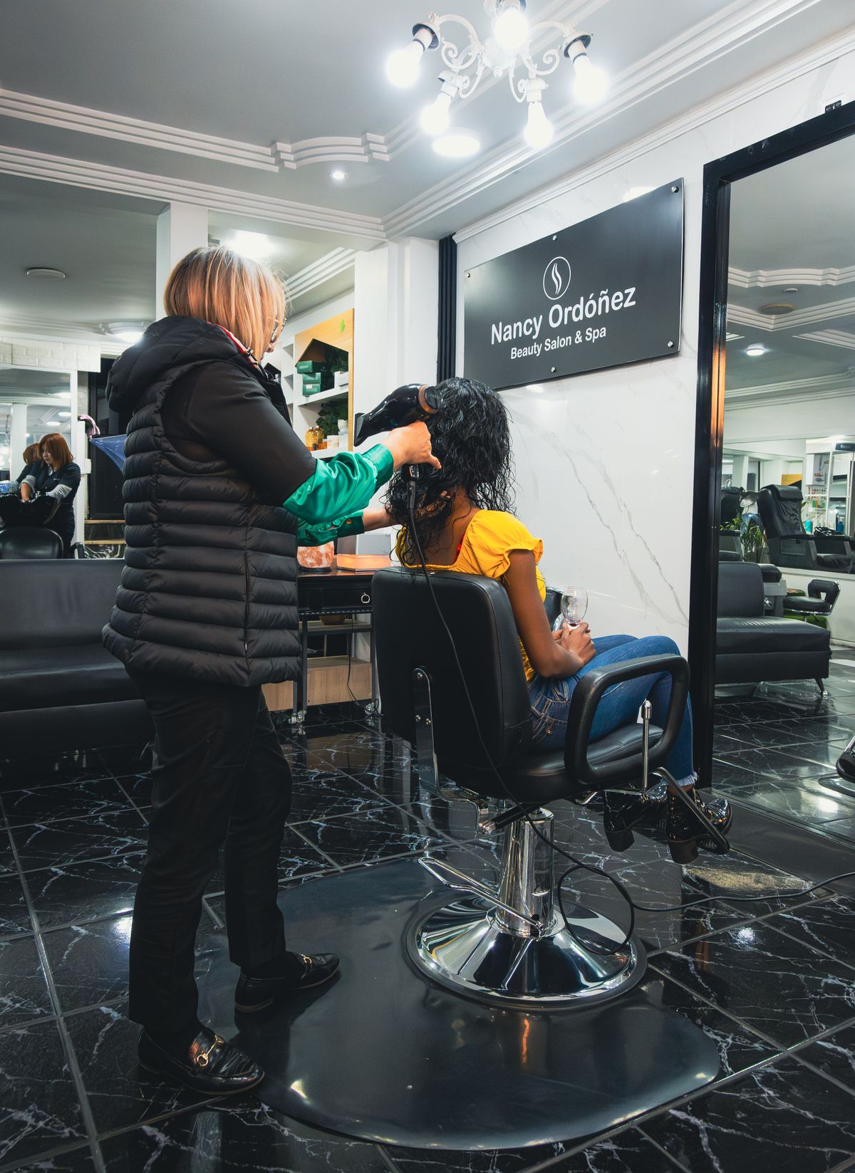 Hair being styled in a salon
