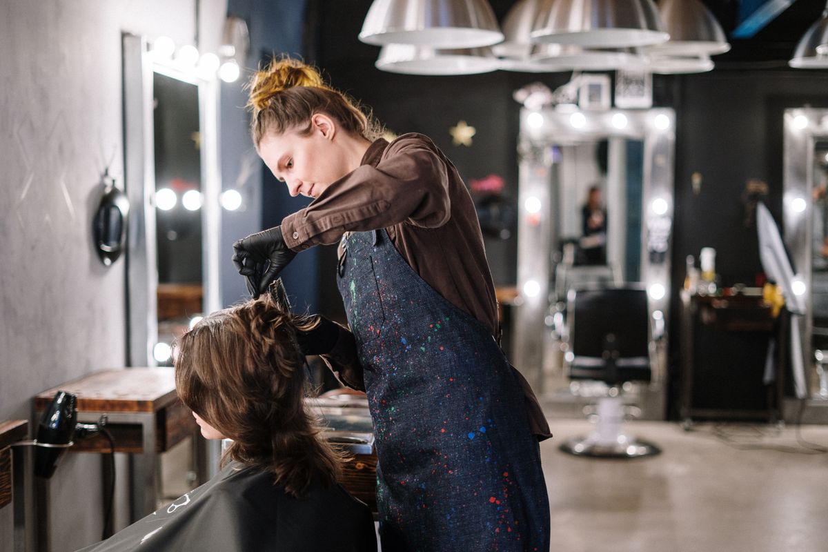 Stylist applying hair color to a client