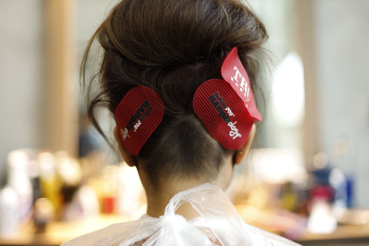 Foils and clips in a client's hair during highlighting